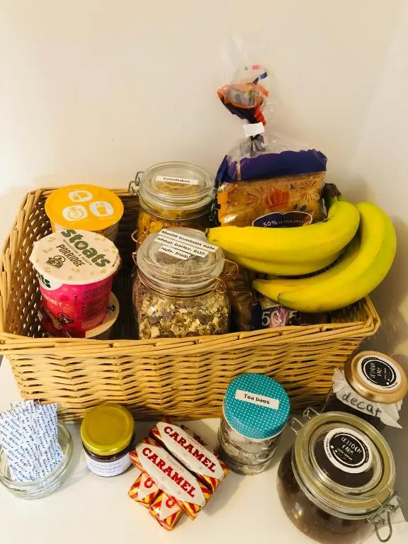 a basket filled with food and bananas in a refrigerator at Lettoch Farm in Dufftown