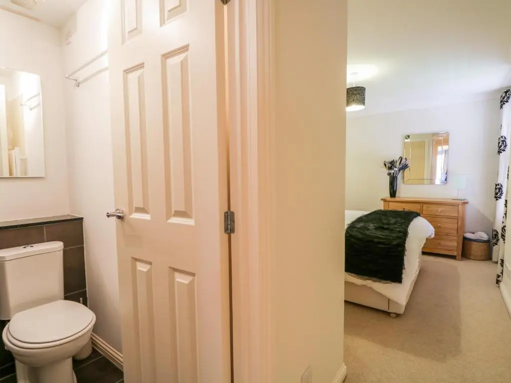 a bathroom with a toilet and a sink at 7 Riverside Gardens in Inverness