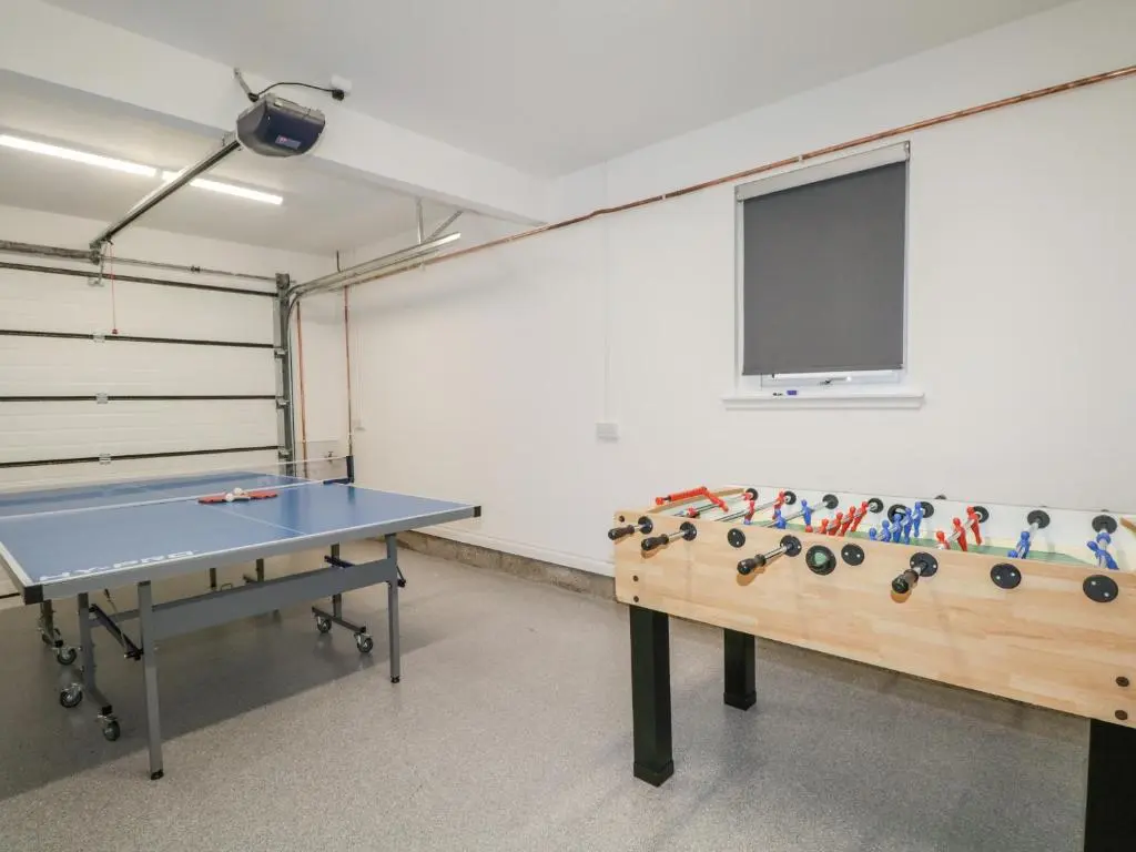 a ping pong room with a ping pong table at 15 Waters Edge in Banff