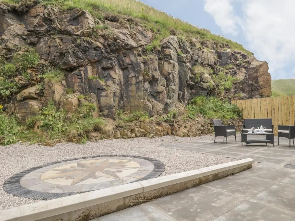 a table and two chairs in front of a mountain at 15 Waters Edge in Banff