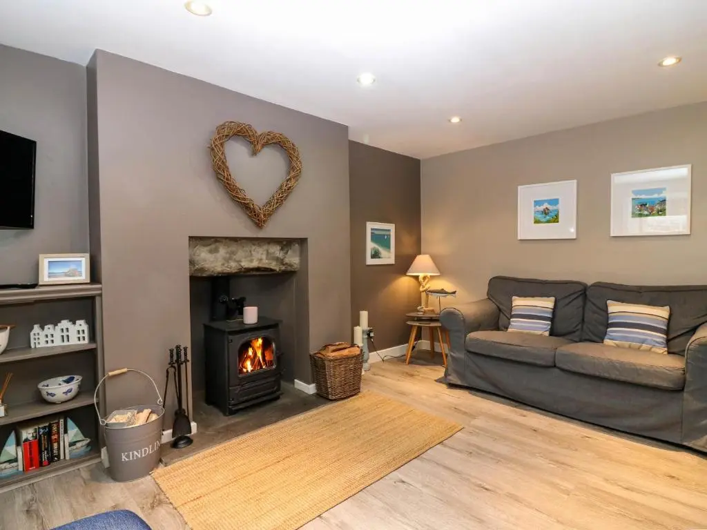 a living room with a couch and a fireplace at 61 Seatown in Buckie