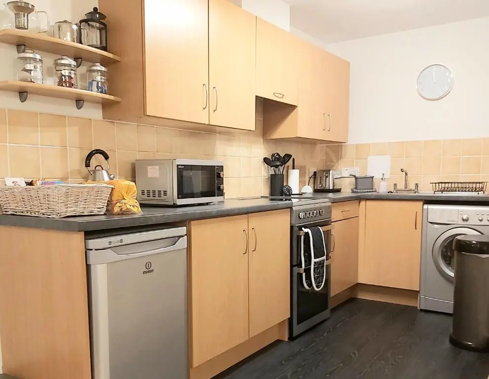 a kitchen with a stove and a dishwasher at Inverness City Centre Apartment with Elevator and Google Chromecast in Inverness