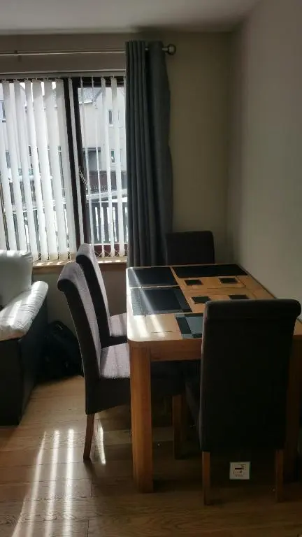 a table and chairs in a room with a window at The Cobblers in Inverness