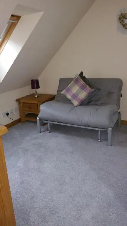 a bed with a pillow on it in a room at The Cobblers in Inverness