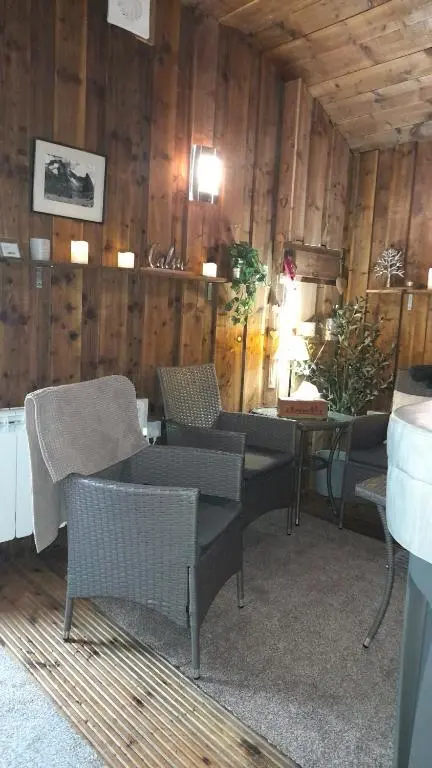 a room with chairs and a table in a building at The Dookit - Aviemore Town House in Aviemore