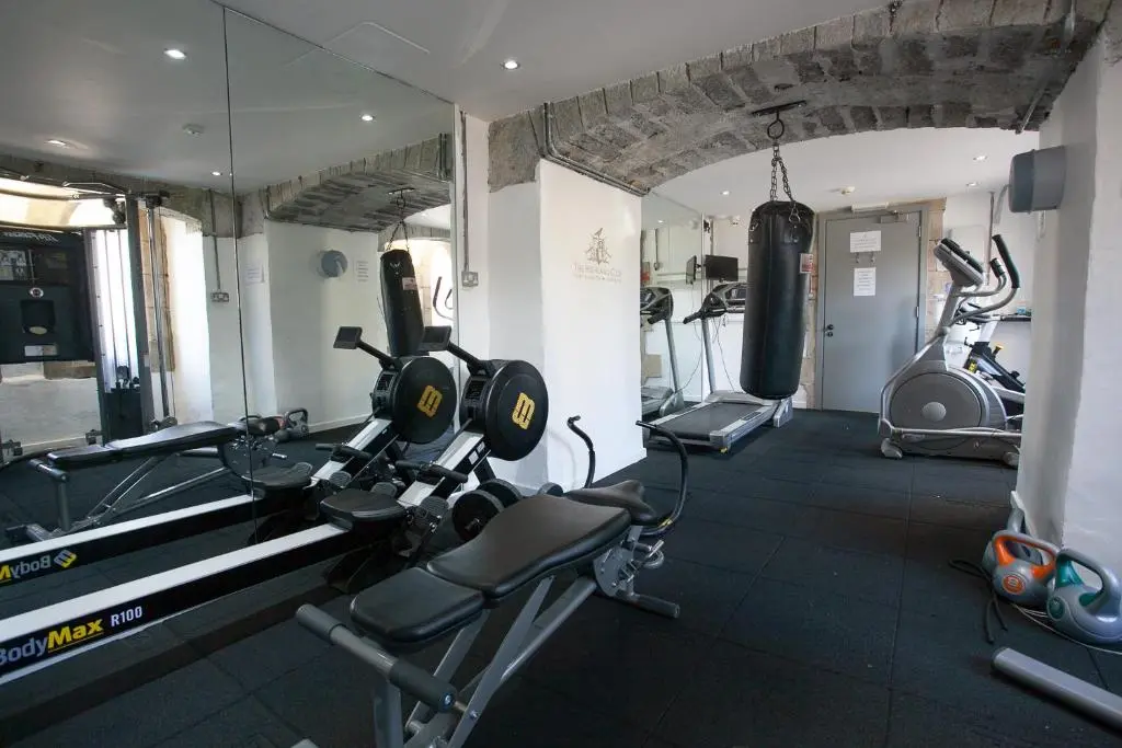 a gym with two treadmills and two exercise bikes at Loch Ness Abbey Cottages in Fort Augustus