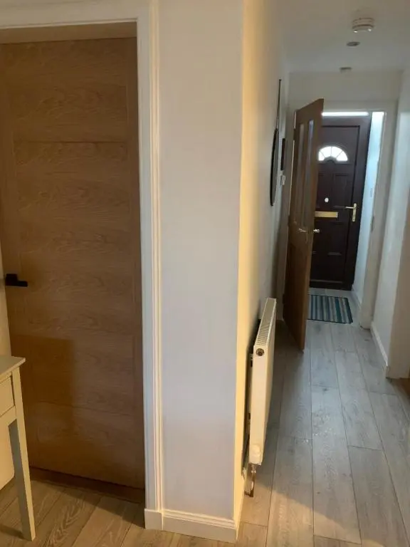 a hallway with a door leading to a room with a hallway at Church view in Wick