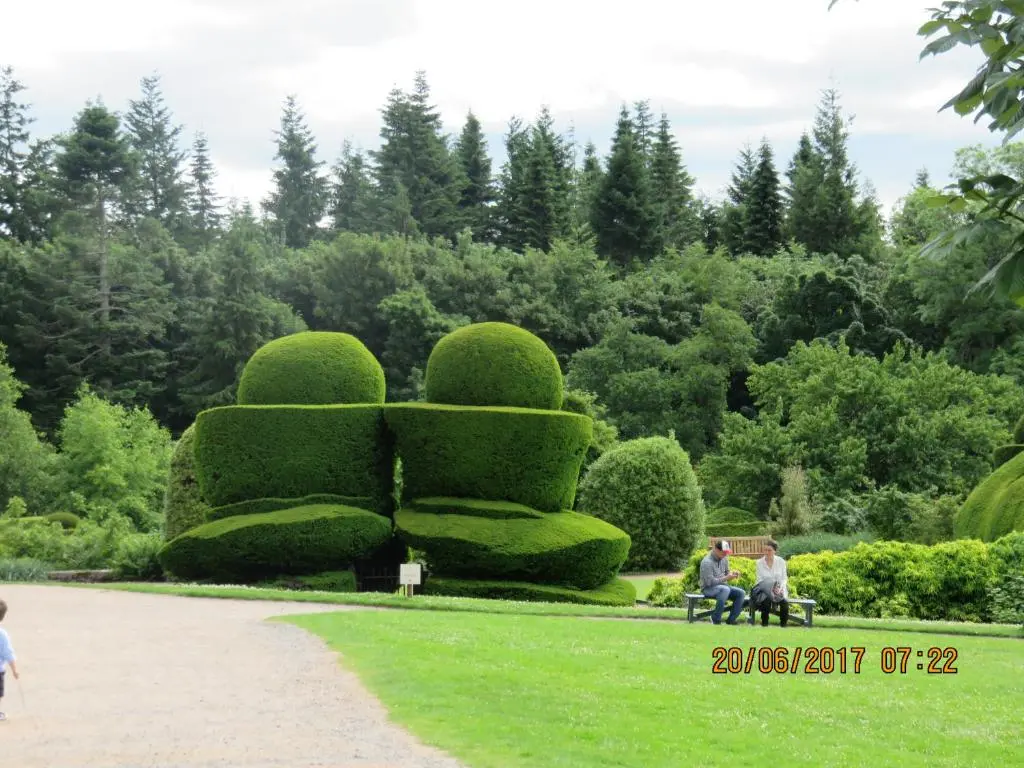 a group of people sitting on a bench in a park at Apartment 20 Inchmarlo in Banchory