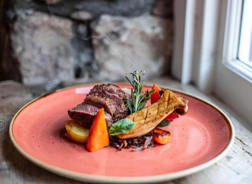 a plate of food with meat and vegetables on a table at Blackfriars in Inverness