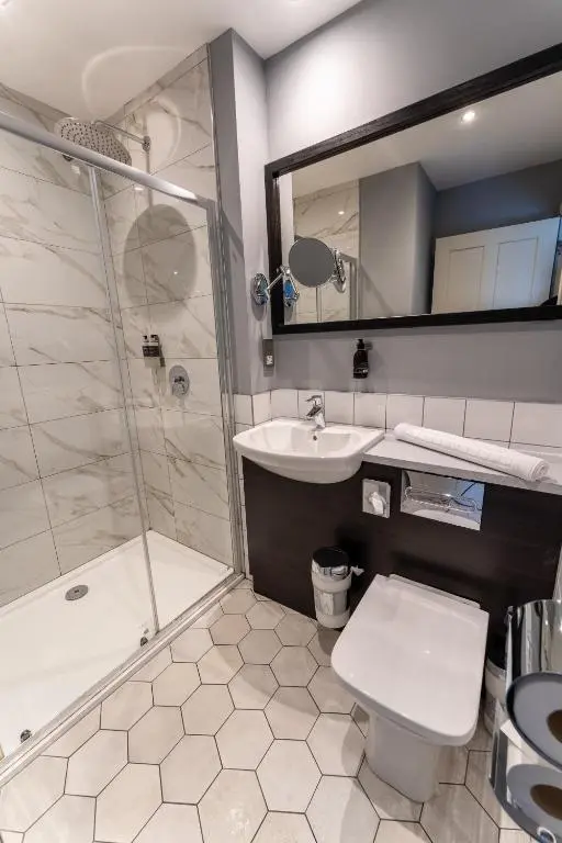 a bathroom with a toilet and a sink and a shower at Blackfriars in Inverness