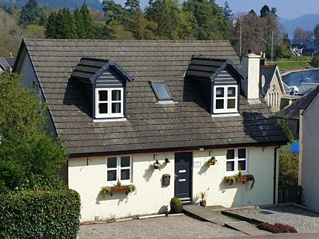 a white house with a black roof at Lorien House B&B in Fort Augustus