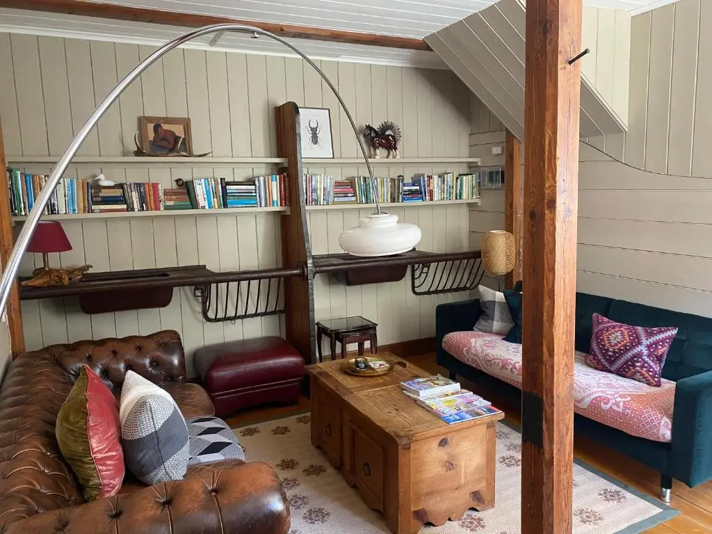a living room with a couch and a table at Stable Cottage, CrannachCottages in Garve