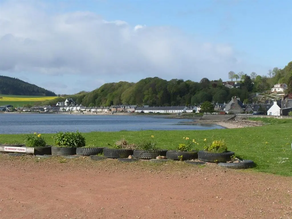 a group of plants in a field next to a body of water at Black Isle Holiday Apartments in Avoch