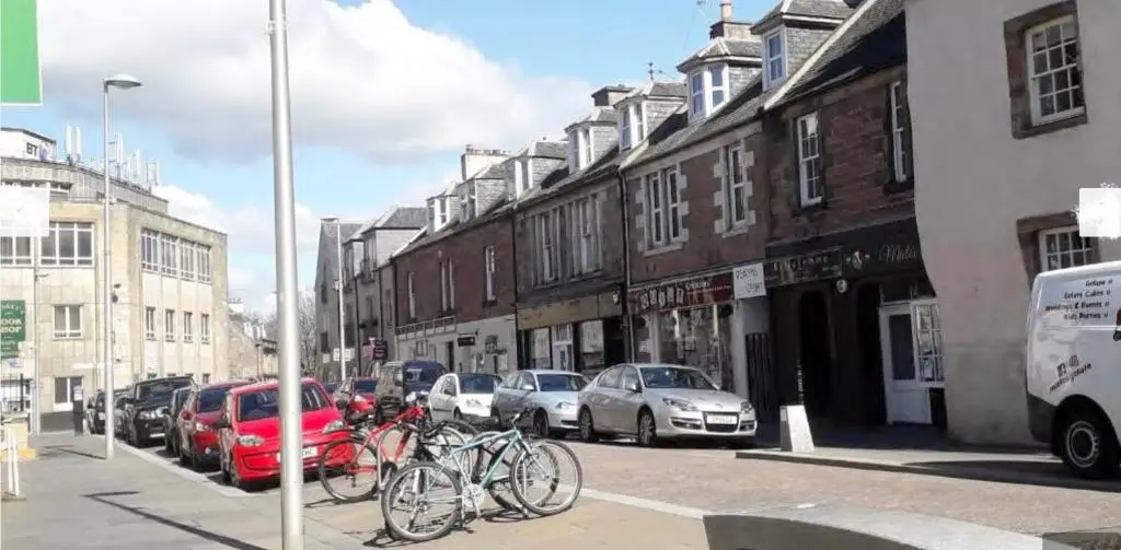 a group of bikes parked on a city street at City Centre House in Inverness
