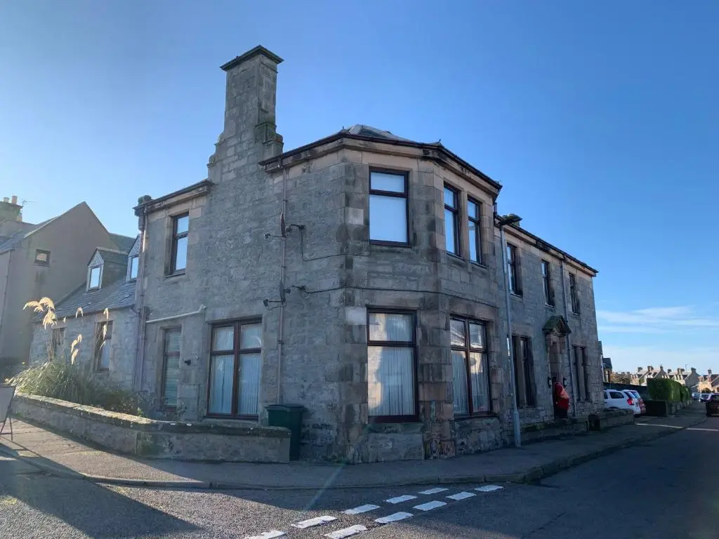 an old stone building on the side of a street at Hayfield Apartment in Lossiemouth