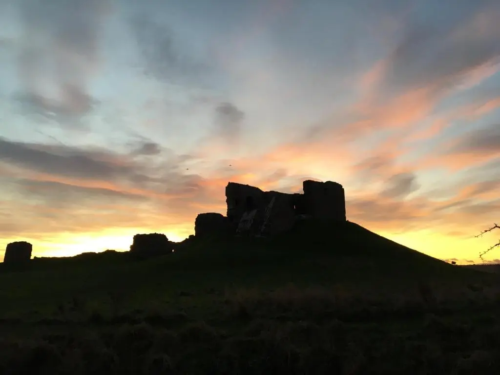 a silhouette of a rock formation at sunset at Hayfield Apartment in Lossiemouth