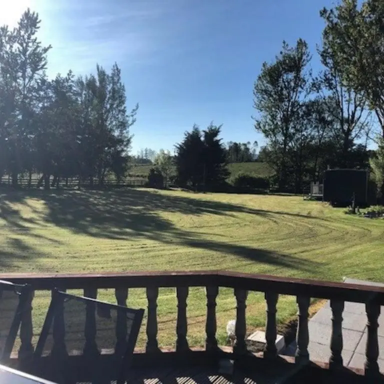 a park bench with a view of a field at Stunning 7 Bedroom Bungalow Alford Aberdeenshire in Alford