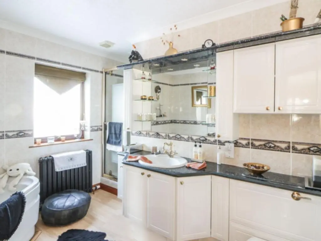 a bathroom with a sink and a mirror at Stunning 7 Bedroom Bungalow Alford Aberdeenshire in Alford