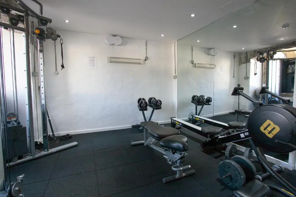 a room with a gym with weights and machines at One Bedroom Apartment Highland Club Scotland in Fort Augustus