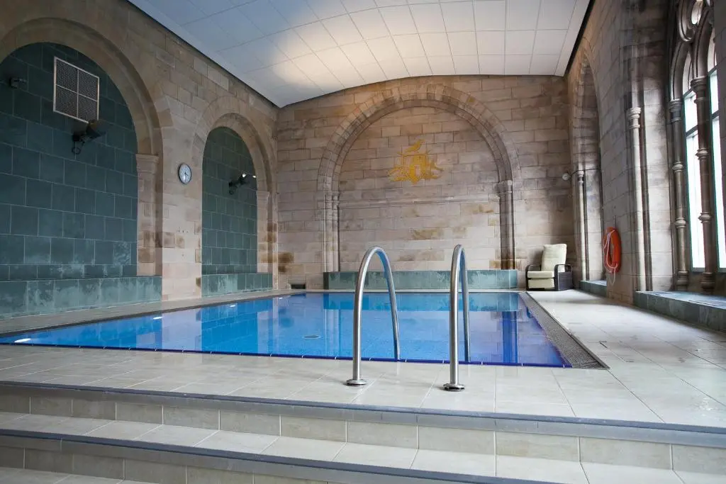 a large swimming pool in a large building at One Bedroom Apartment Highland Club Scotland in Fort Augustus