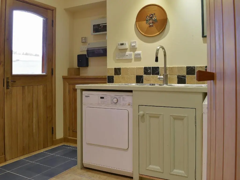 a kitchen with a sink and a dishwasher at Mill Of Burncrook in Glenlivet