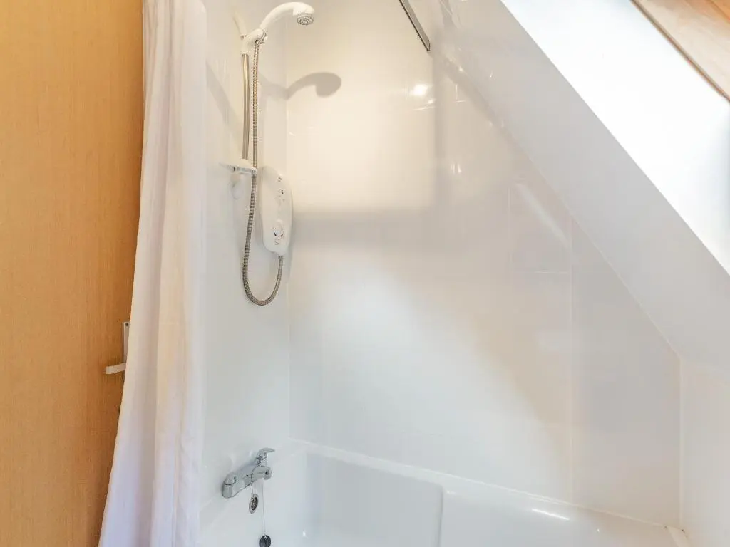 a bathroom with a shower and a bath tub at Gorse Lodge - Uk7050 in Glenurguhart