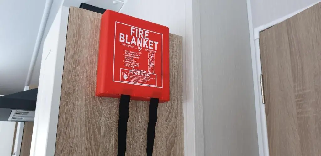 a fire danger sign is hanging on a door at Bonnie Gorm in Boat of Garten
