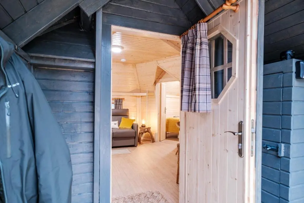 an open door to a tiny house with a living room at Cairngorm Bothies in Aboyne