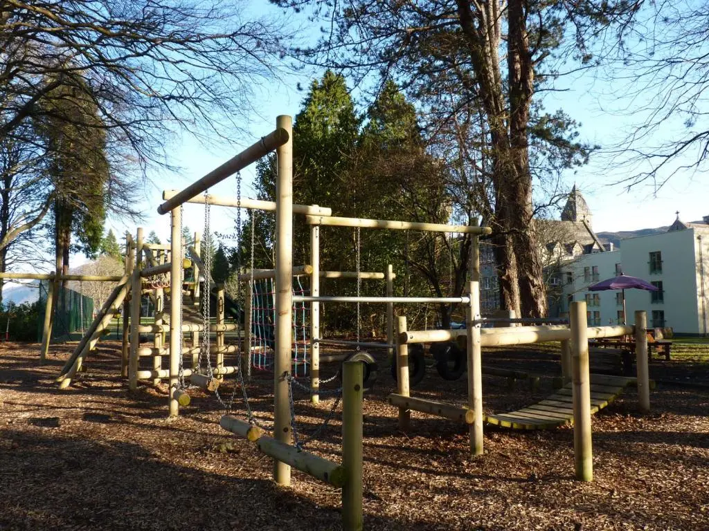 a park with a playground with a slide at Loch Ness Moat House Apartments in Fort Augustus
