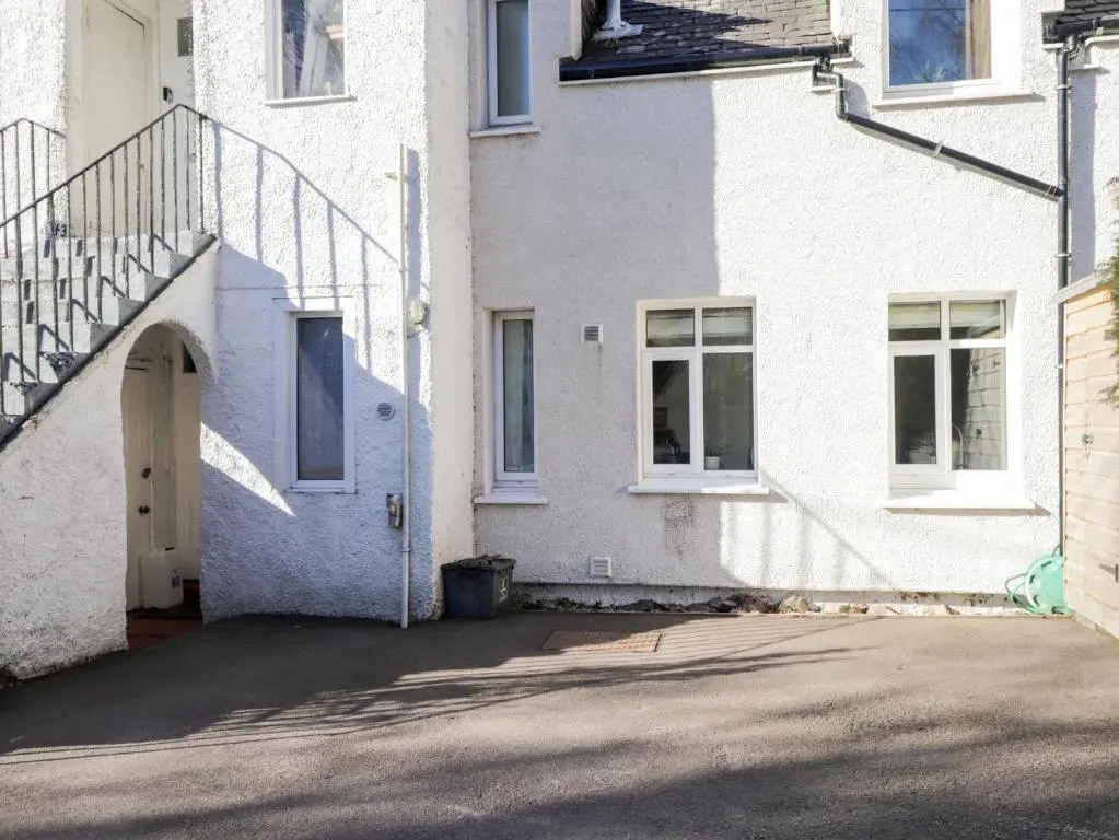 a white house with a staircase and a driveway at Faodail Glenlia in Foyers