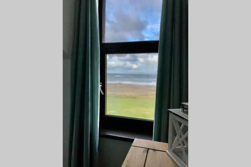 a room with a window with a view of the ocean at Skerry View - Overlooking the Moray Firth - close to Beaches, Harbour, Shops and Restaurants in Lossiemouth