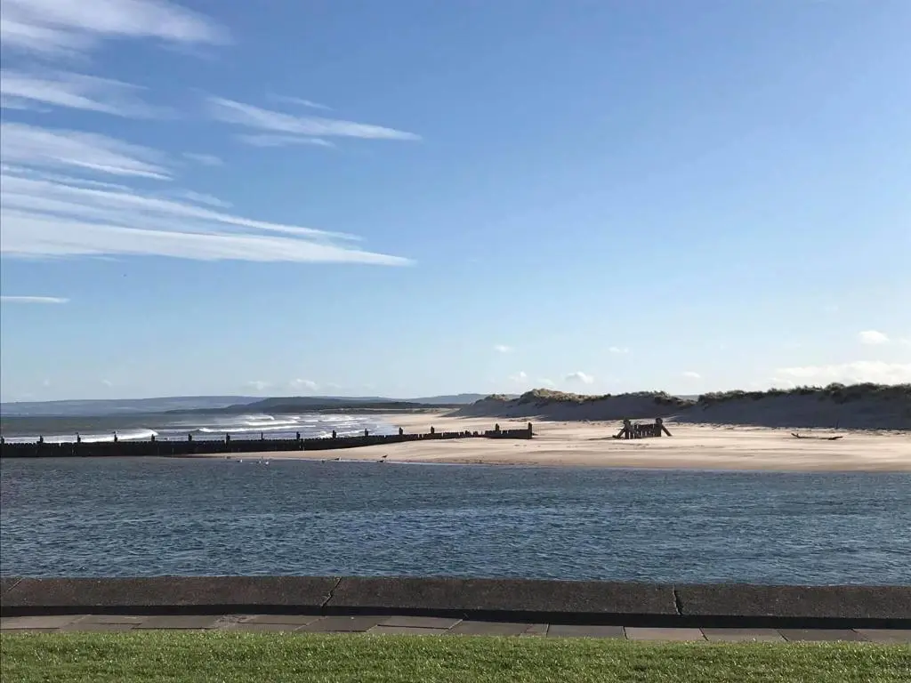 a beach with a body of water next to a beach at Skerry View - Overlooking the Moray Firth - close to Beaches, Harbour, Shops and Restaurants in Lossiemouth