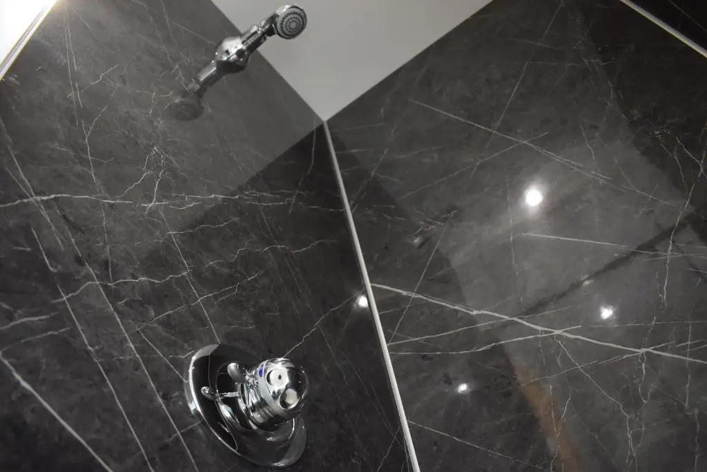 a bathroom with a shower with a faucet at Grantown Caravan Park in Grantown on Spey