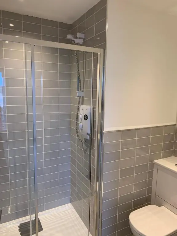 a shower stall in a bathroom with a toilet at Atholl Place View in Inverness