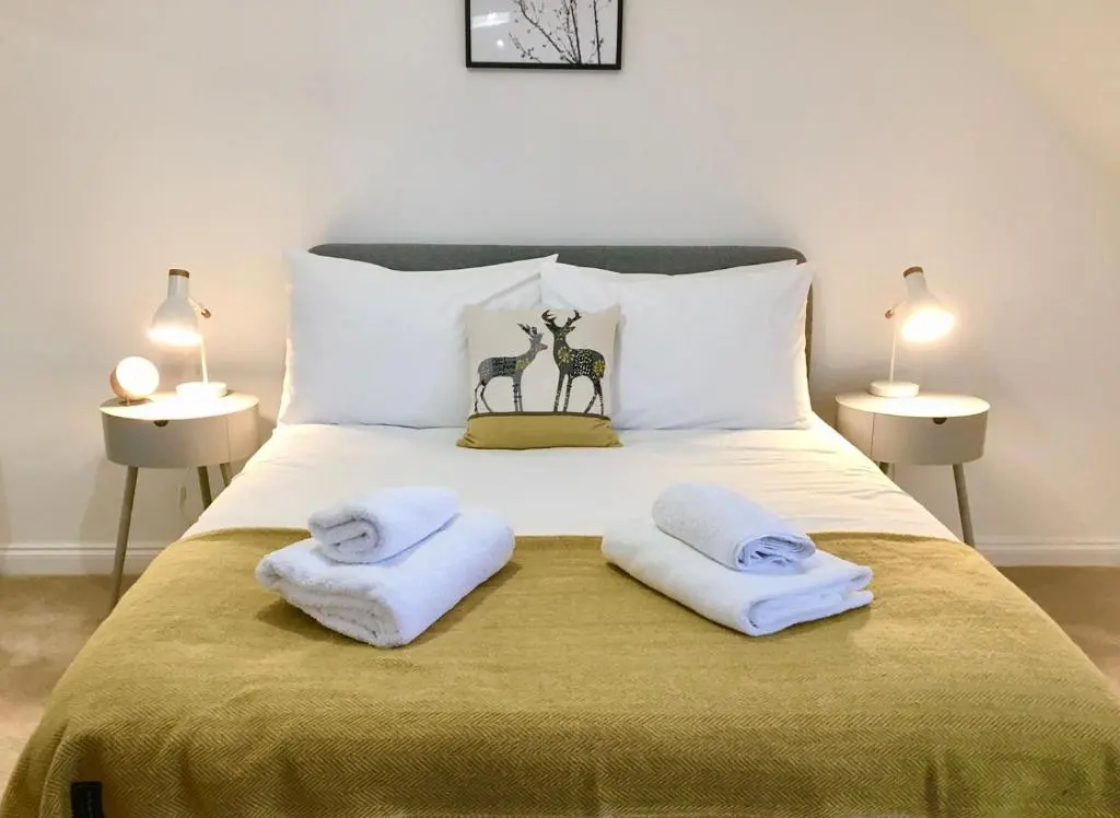 a bedroom with a bed with towels on it at The Tack Room in Inverness