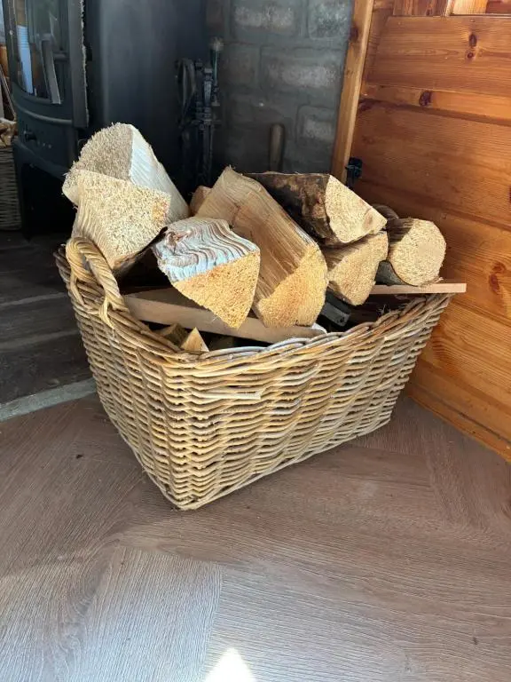 a basket sitting on the floor next to a door at Deveron Valley Cottages in Marnoch
