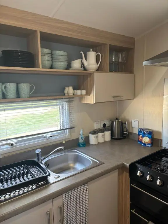 a kitchen with a sink and a stove at Paul\u2019s place silversands in Lossiemouth