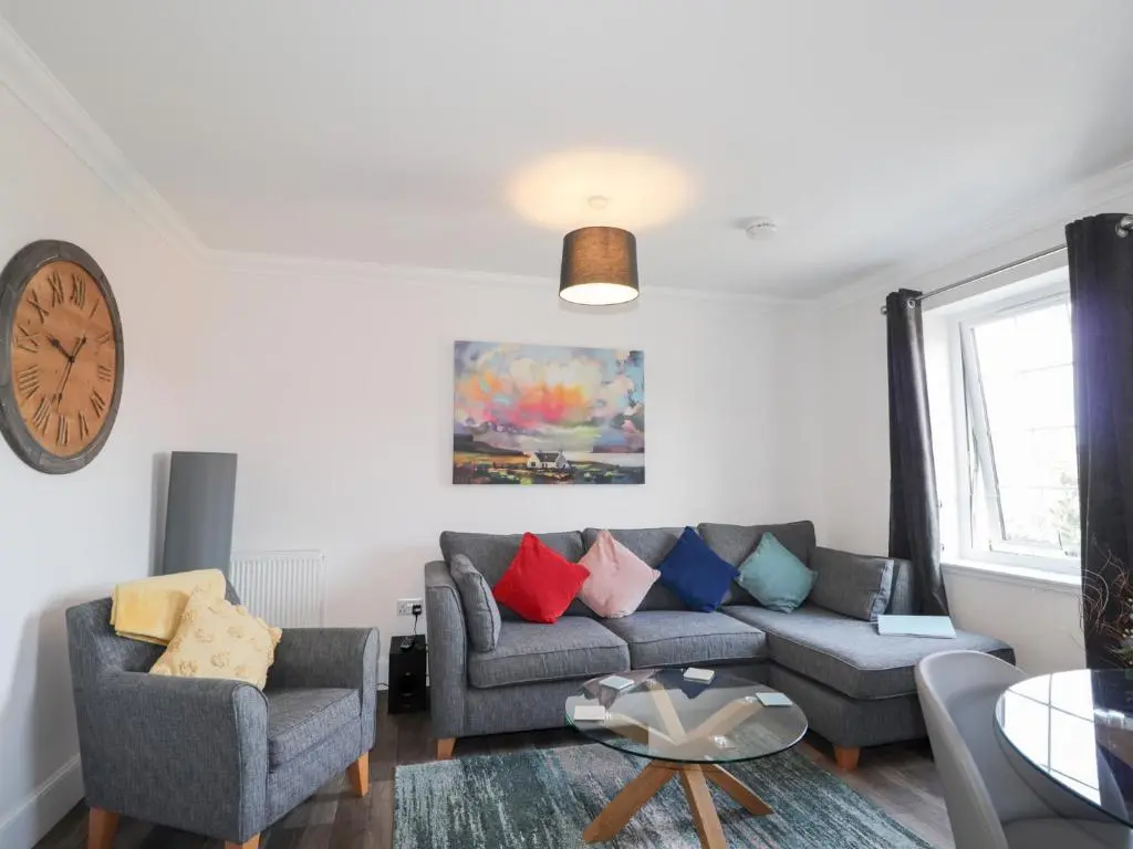 a living room with a couch and two chairs at The Nook in Inverness