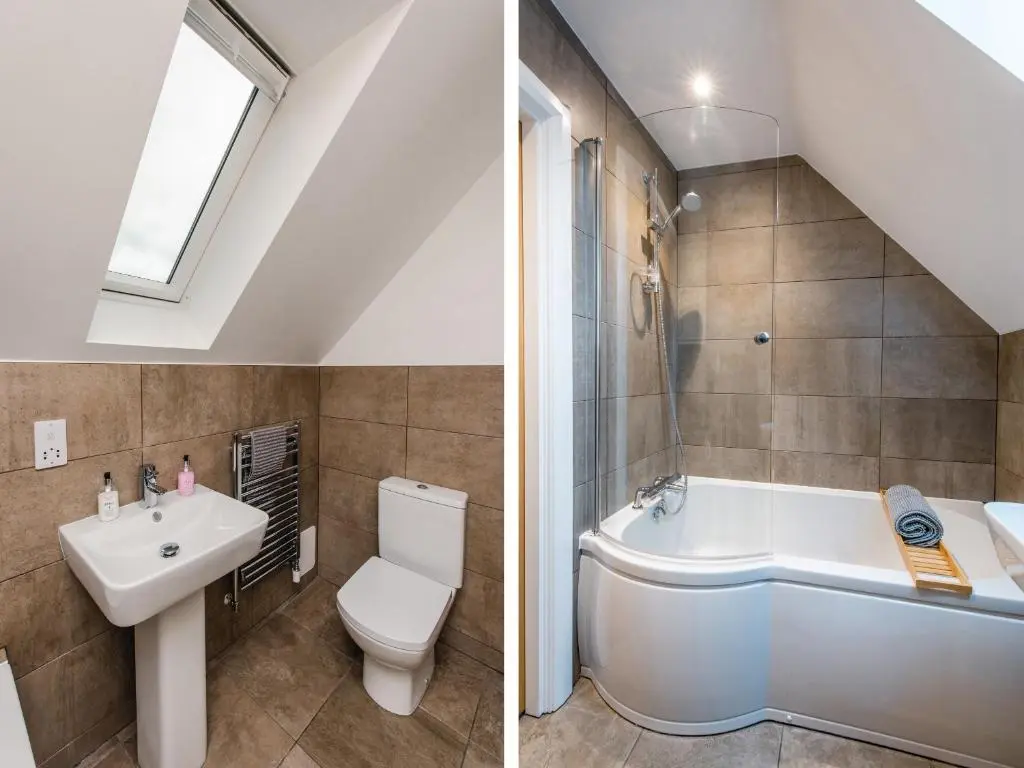 a bathroom with a sink and a toilet and a tub at Golden Eagle Lodge in Kingussie