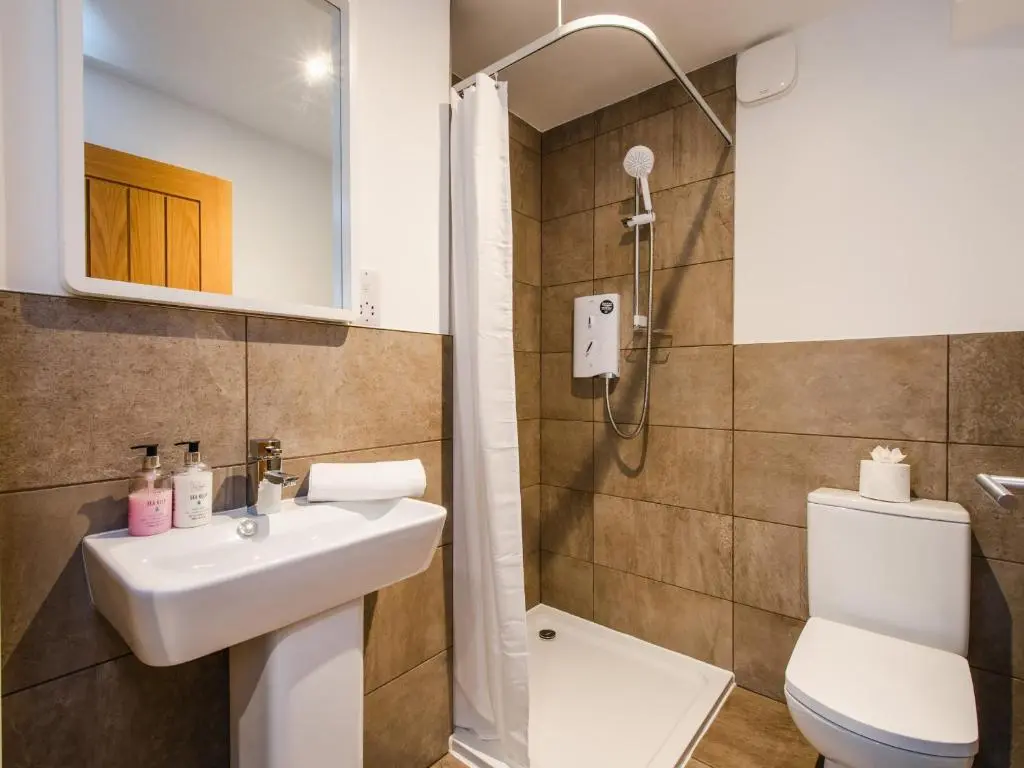 a bathroom with a sink and a toilet at Mountain Hare Apartment in Kingussie