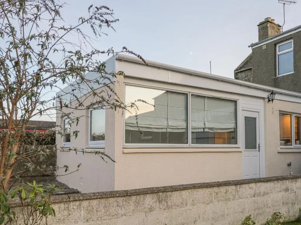 a house with large windows on a wall at The Neuk in Elgin
