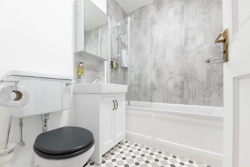 a bathroom with a black toilet and a shower at Old Edinburgh Court in Inverness