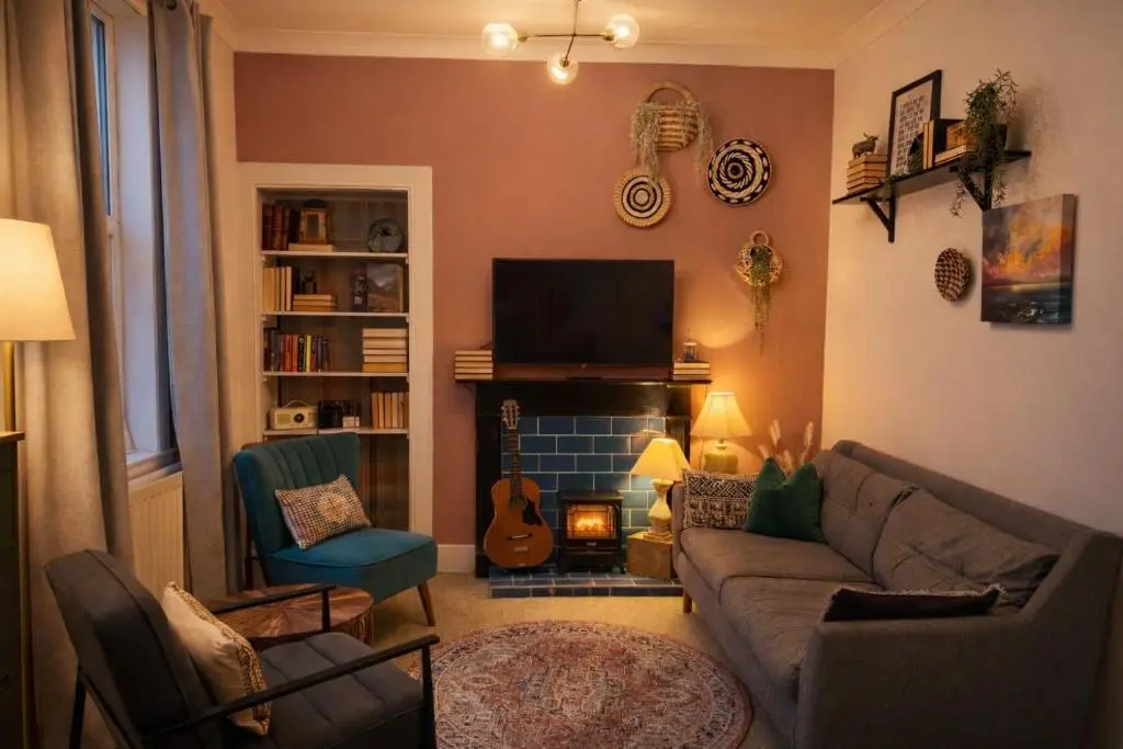 a living room with a couch and a fireplace at Lamont Cottage in Inverness