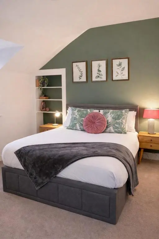 a bedroom with a large bed in a room at Lamont Cottage in Inverness