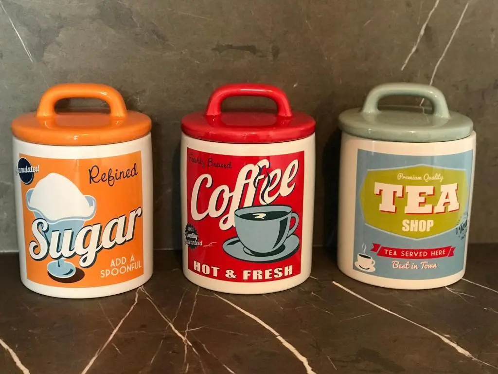 three cans of coffee and tea sitting on a counter at The Steamboat - A Flat with Amazing Harbour Views in Wick