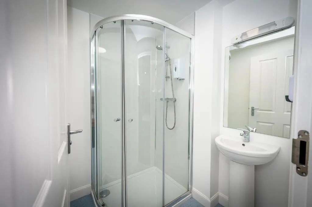 a bathroom with a glass shower and a sink at Loch Ness Bunk Inn in Drumnadrochit