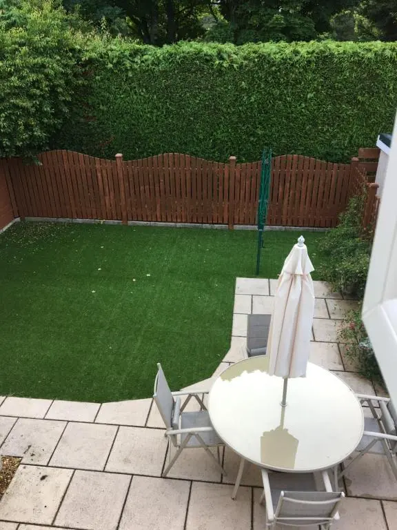 a patio with a table and chairs and a lawn at Crescent Corner, Inverness in Inverness