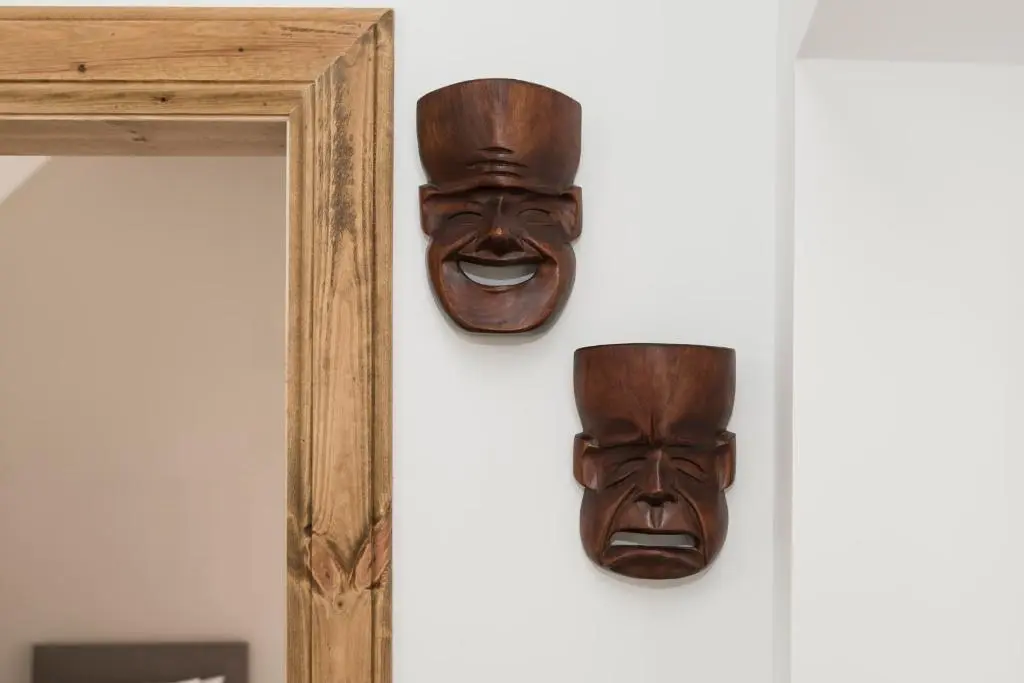 a pair of wooden masks hanging on a wall at The Milking Sheds, Dufftown in Dufftown