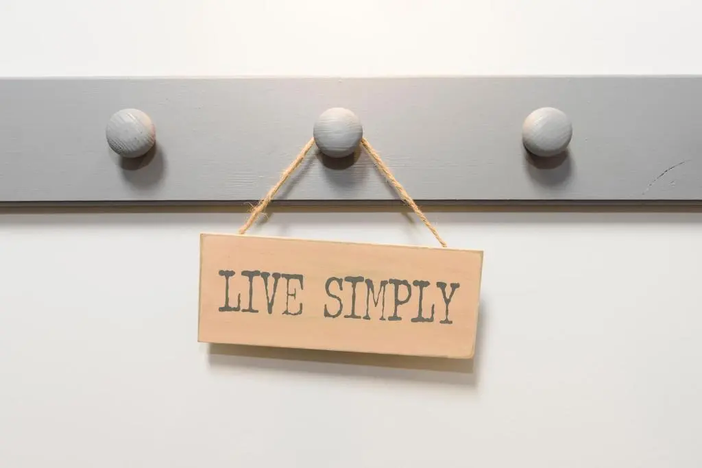 a sign that says live simply hanging on a wall at The Milking Sheds, Dufftown in Dufftown