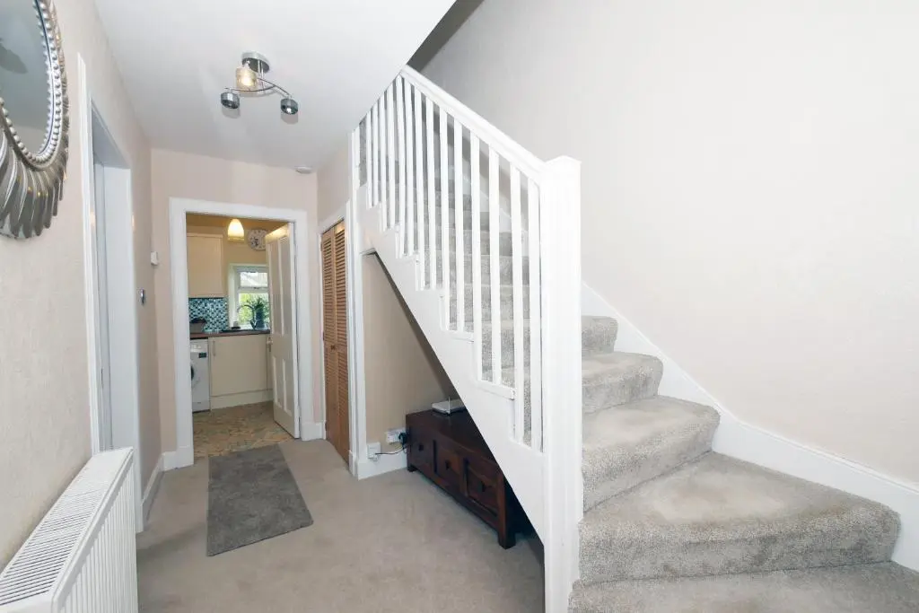 a staircase in a home with white walls at Ardentorrie Holiday Home in Inverness